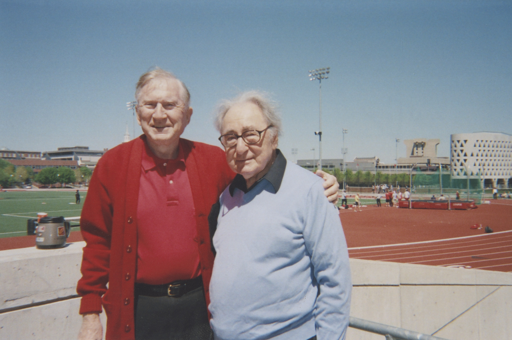 A color photo of Gettler and former UC President, Henry Winkler, at Gettler Stadium.
