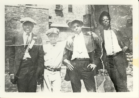 A black and white photo of a group of 4 boys