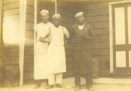Black and white photo of Berry as a kitchen hand with two other men