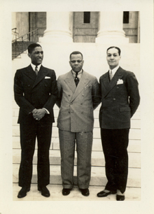 Black and white photo of three men in front of the steps of the Supreme Court. Berry is on the right