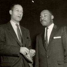 Black and white photo of Ted Berry and Martin Luther King Jr. shaking hands