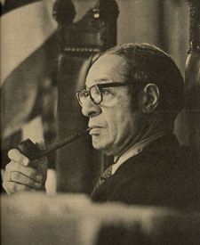 Black and white photo of Ted Berry seated with cigar