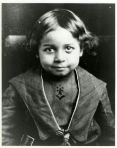 Black and white photo of Theodore Berry as a child seated