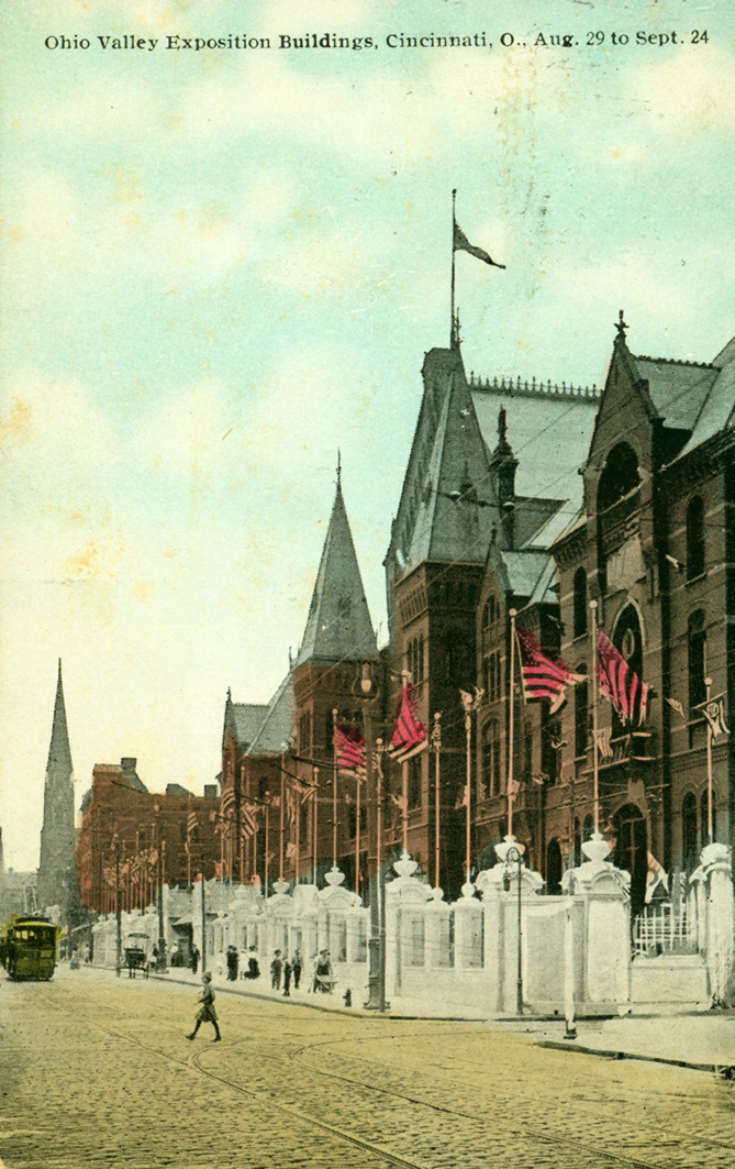 This is a postcard image of the exposition buildings and thoroughfare in front of the exposition. A trolley car can be seen on the far left.