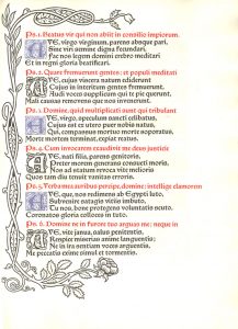 One page of text with a vine motif on the edges and black, blue ,and red text