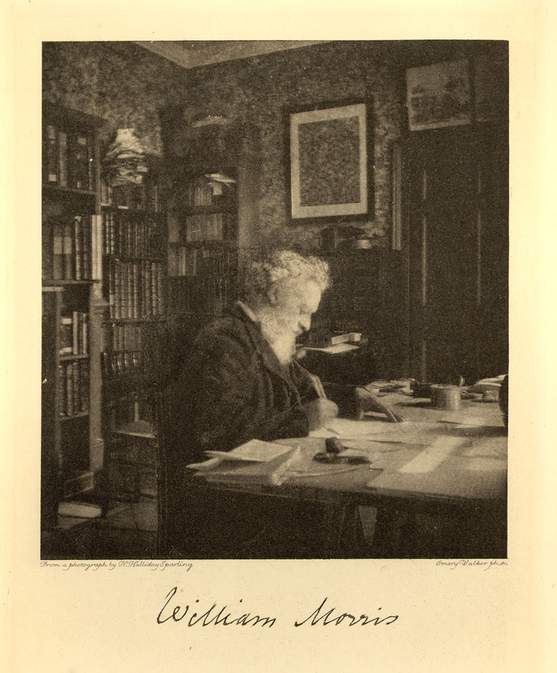 A photograph of Morris at work in his study.
