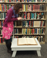 UC Digital Archivist Eira Tansey digitizes a book using her smartphone.