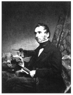 Justus von Liebig (1803-1873) posing with his apparatus for combustion analysis.