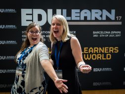 Kellie and Becky posing in front of the EduLearn sign.