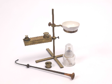 A portable Berzelius oil lamp for blowpipe analysis. The additional ring and alcohol lamp could be used to evaporate mineral water samples for analysis.