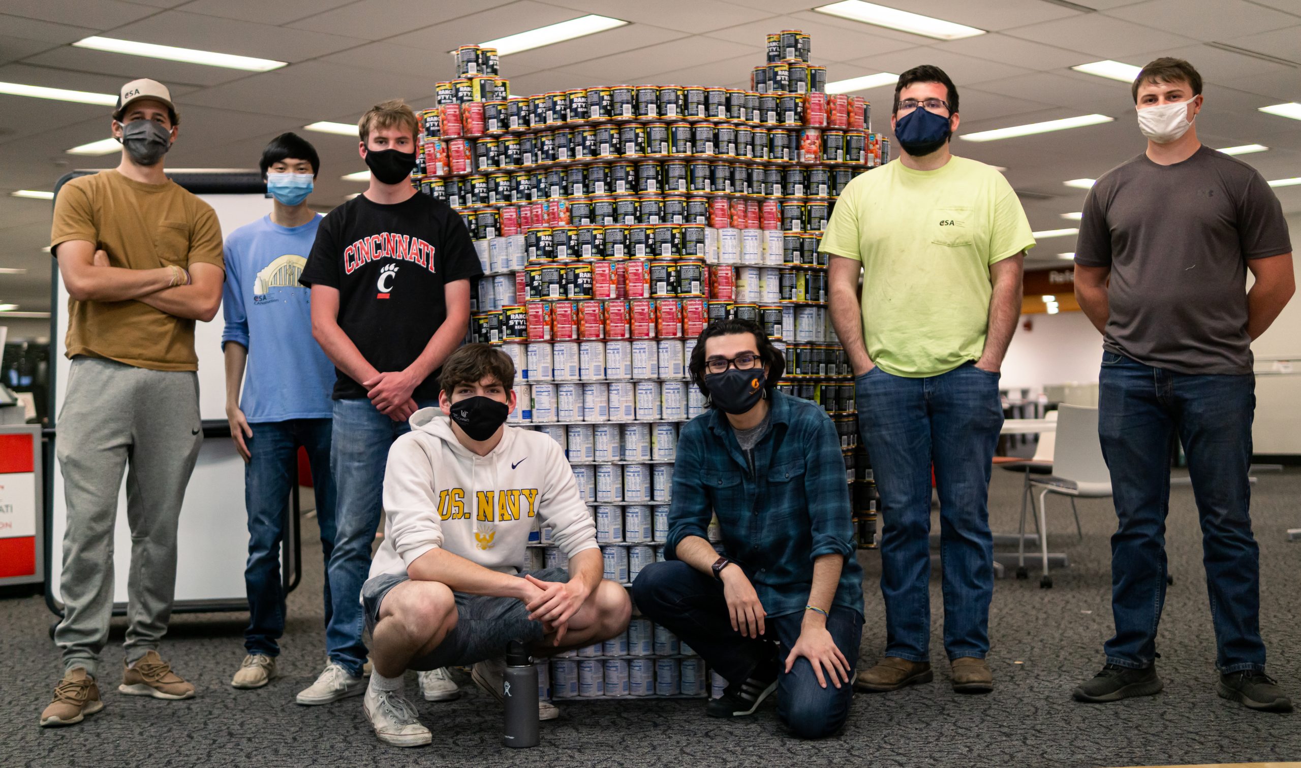 Students from the Construction Student Association pose in front of their canned sculpture