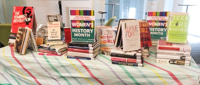 display of books atop a table for women's history month