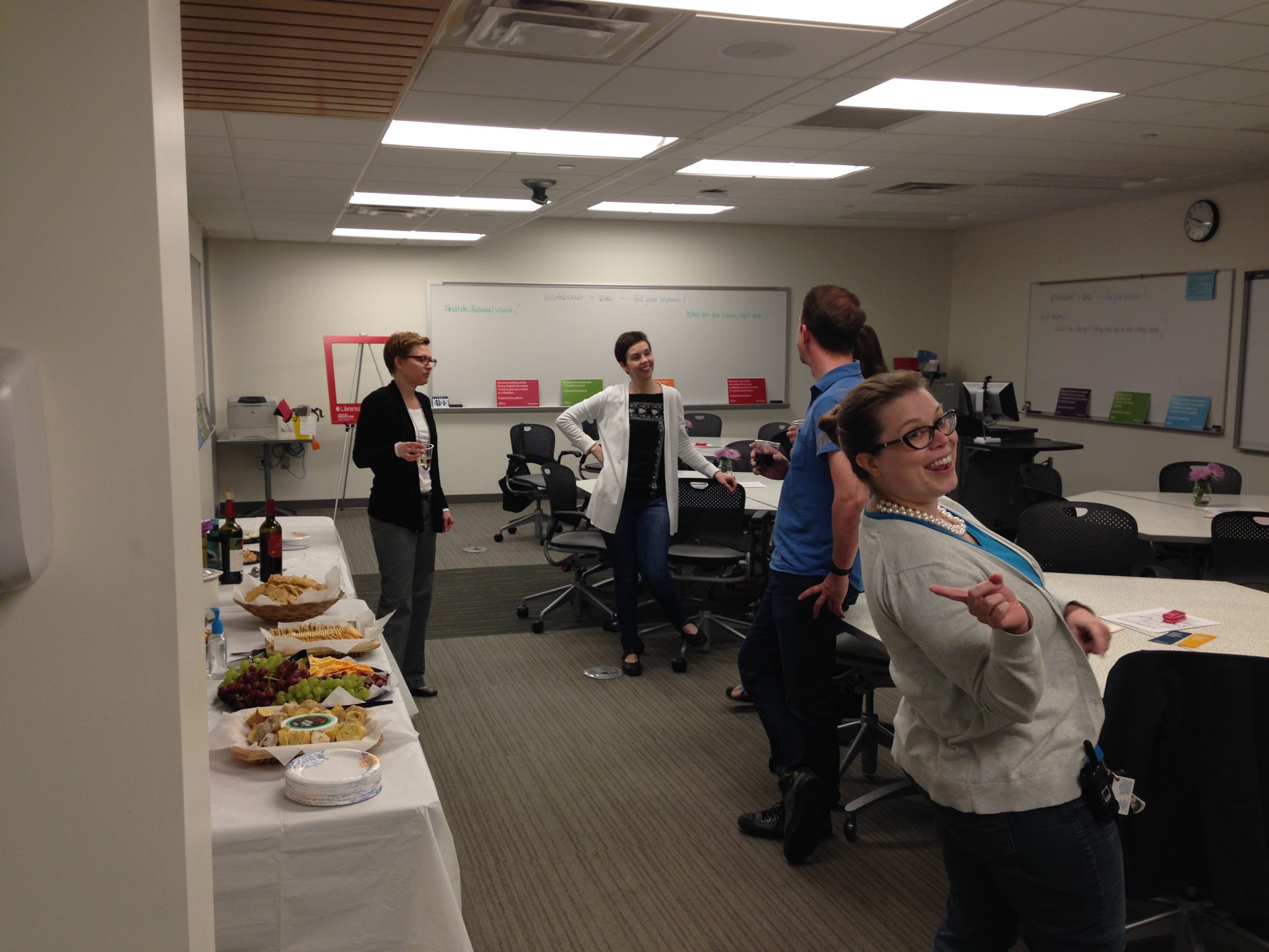 UCBA colleagues standing and socializing over snacks