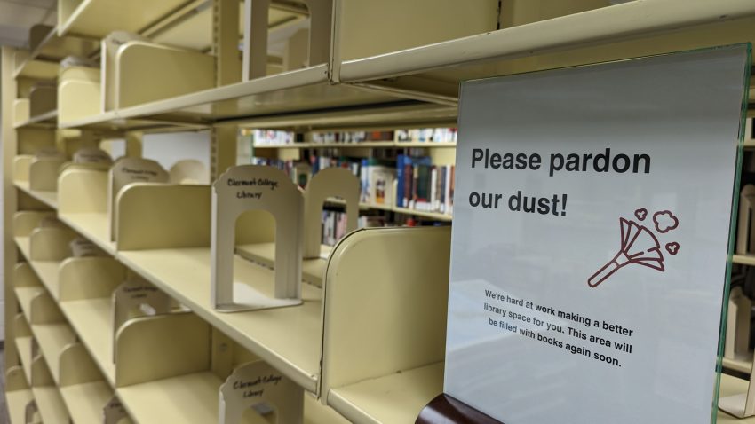 Empty shelves with a pardon our dust sign