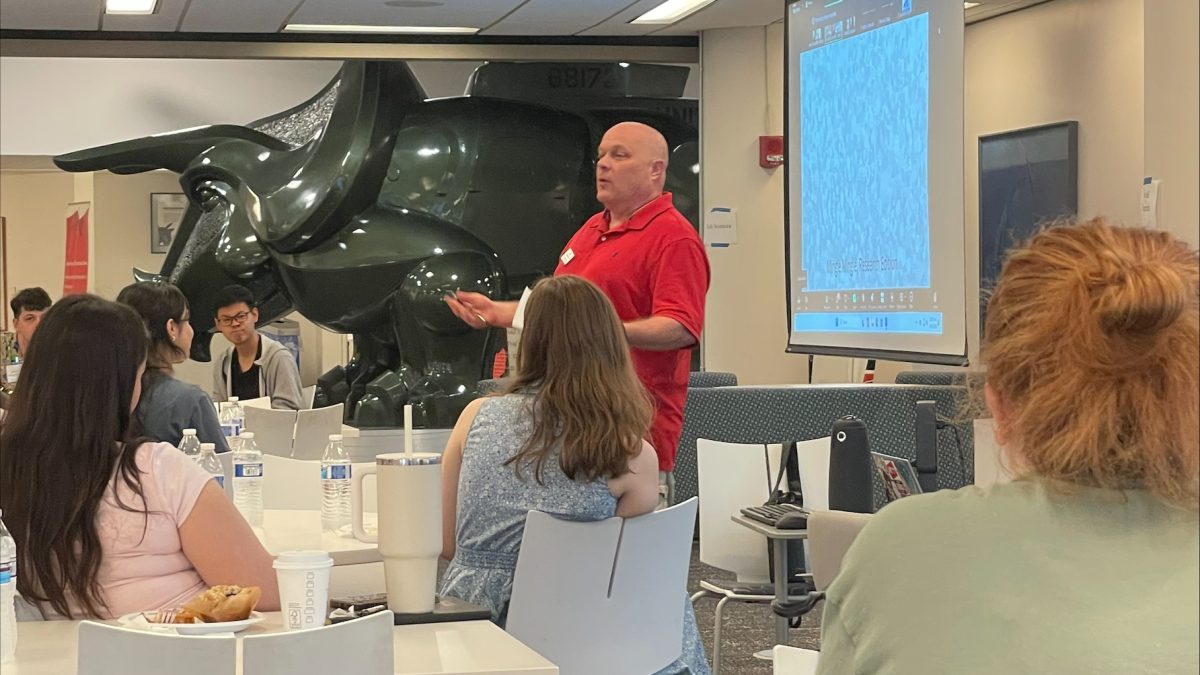 Image of Don Wittrock presenting to students with the triceracopter in the background