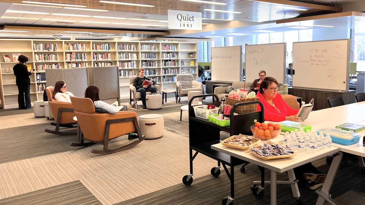 Students and staffed reading and relaxing in the Nook