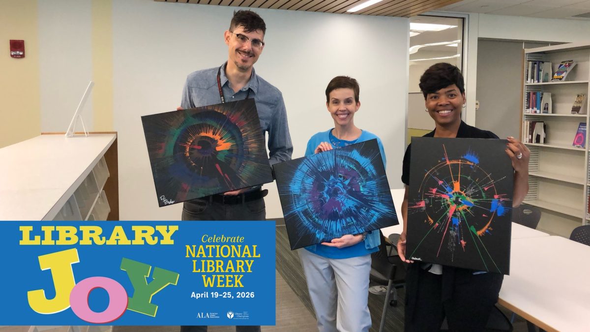 Three library staff members holding their spin art.