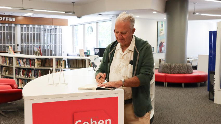 Author signing his book, Voces Jibaros.