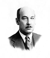 A black and white headshot of a middle aged man.