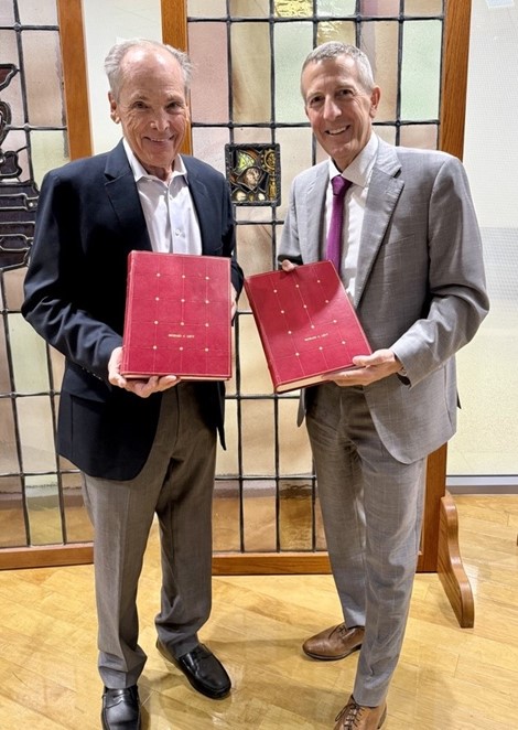 Drs. Richard C. Levy and Gregory J. Fermann holding volumes one and two of Emergency Medicine concepts and clinical practice.