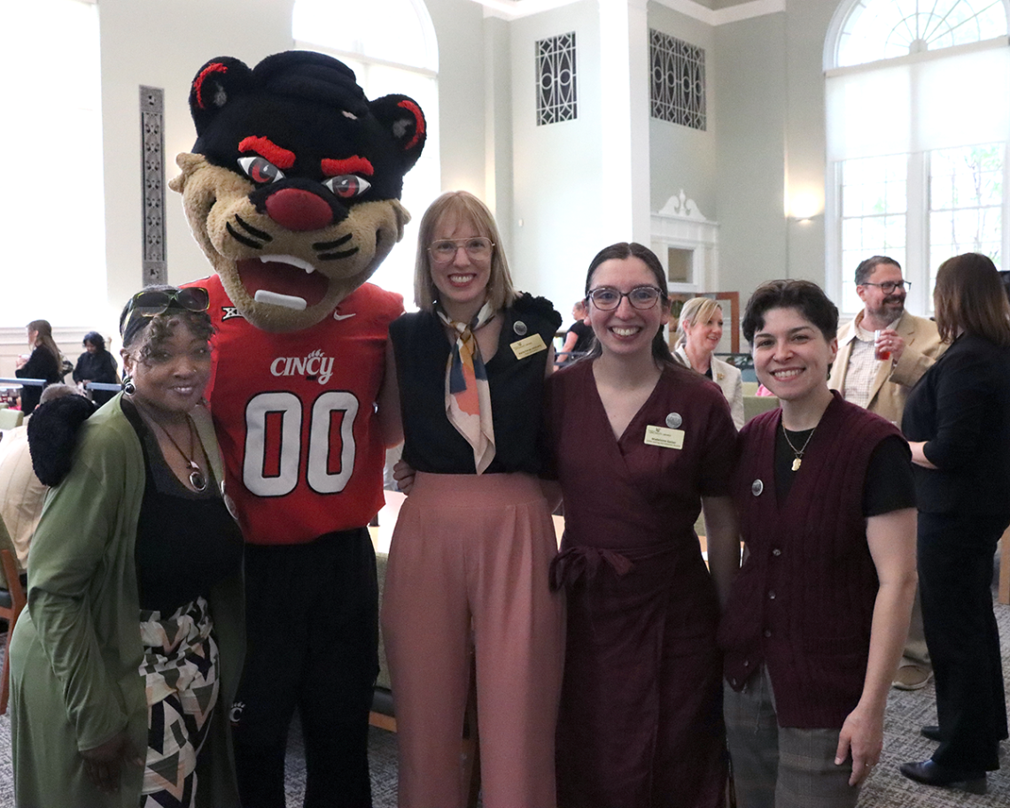 staff pose with the Bearcat