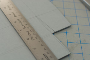Ruler and e flute board with markings of where to cut for box walls and flaps.