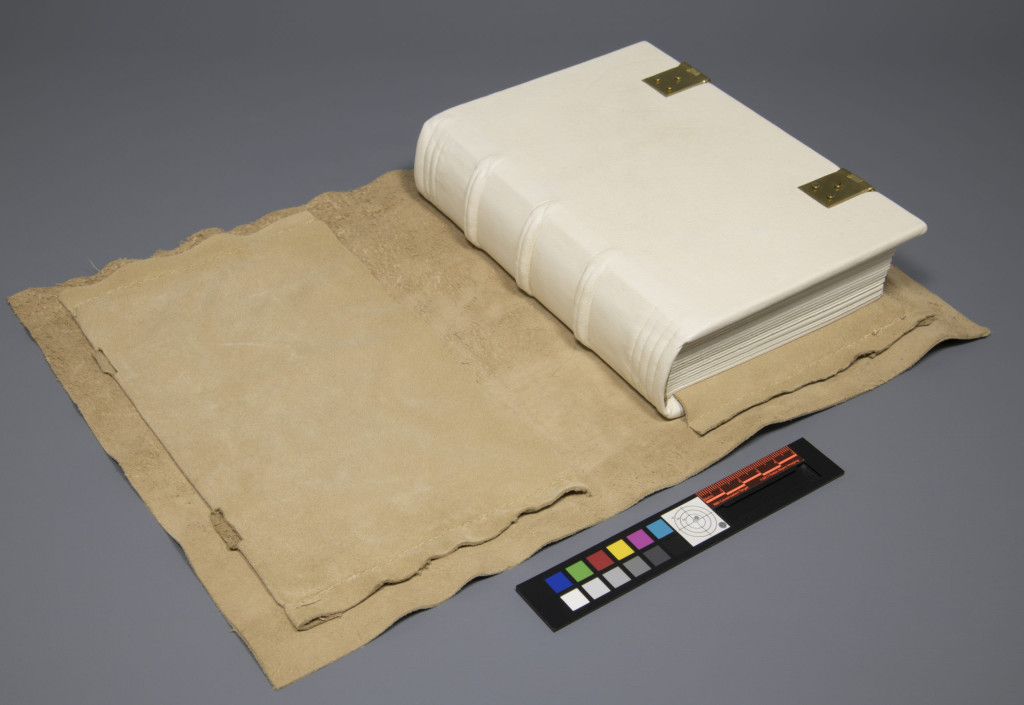 Image of the book of hours model closed. The chemise is attached to the lower board, but not the upper board.