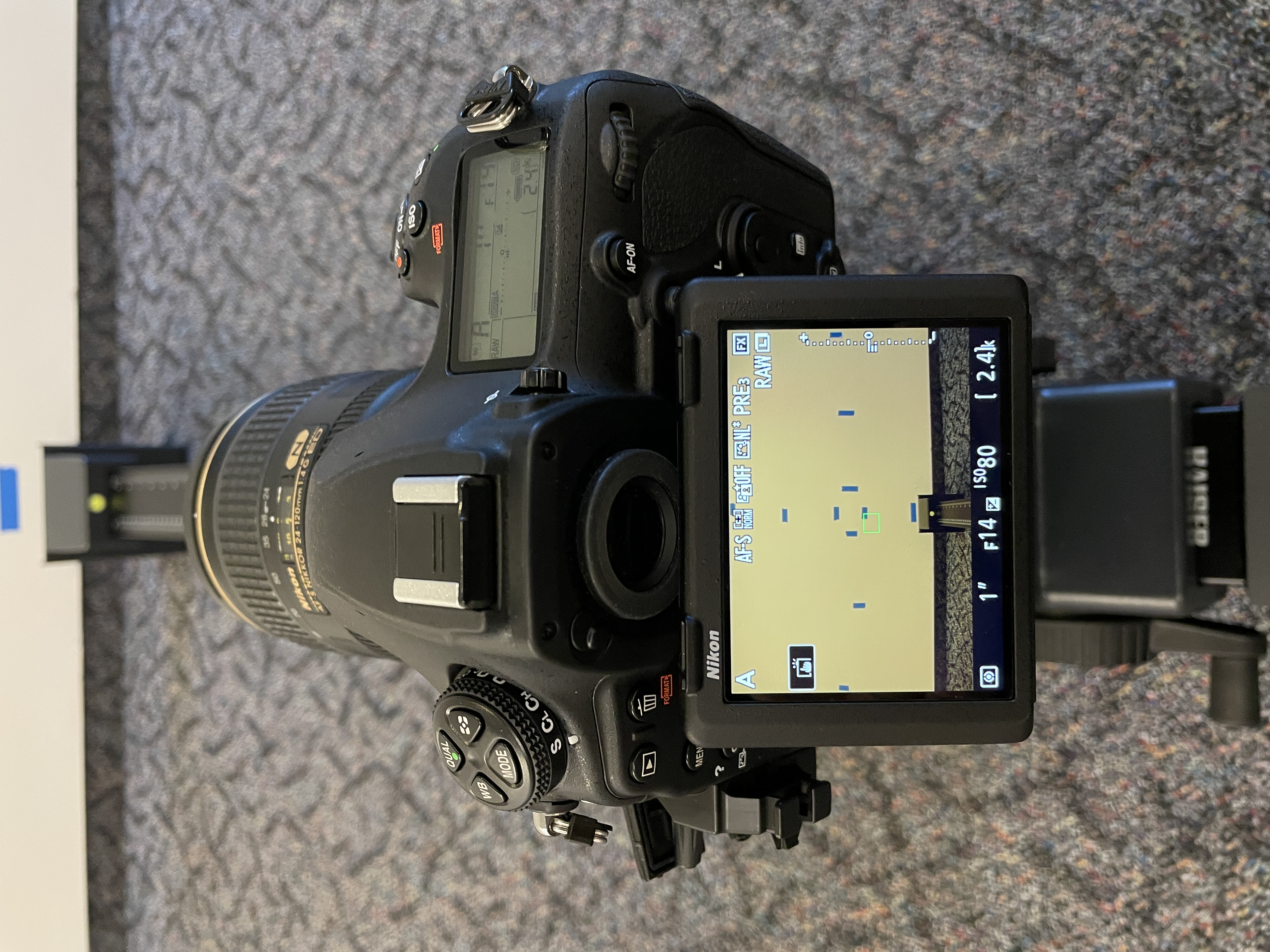 image of a dslr camera screen and blue tape on a wall