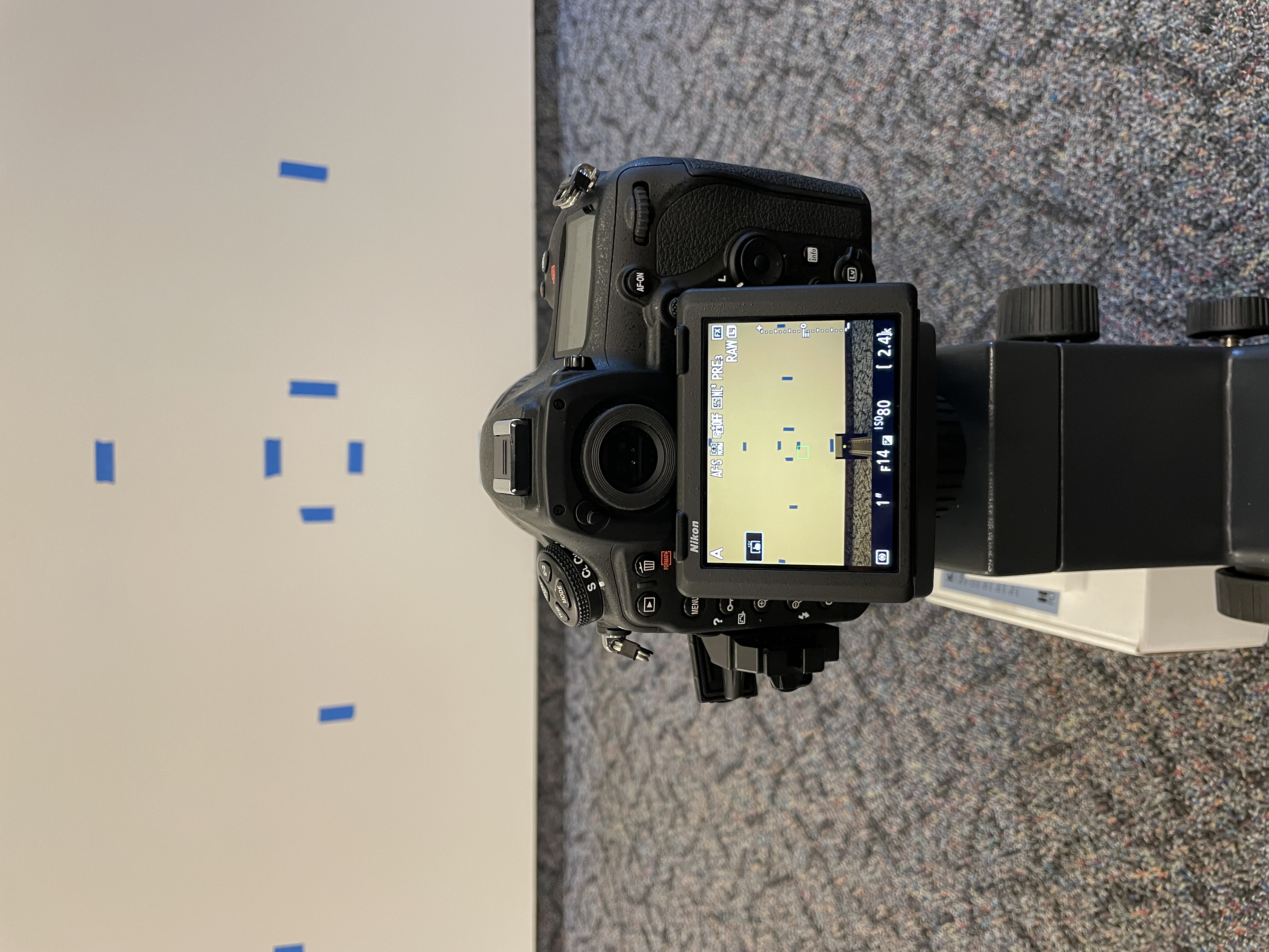 image of a dslr camera screen and blue tape on a wall