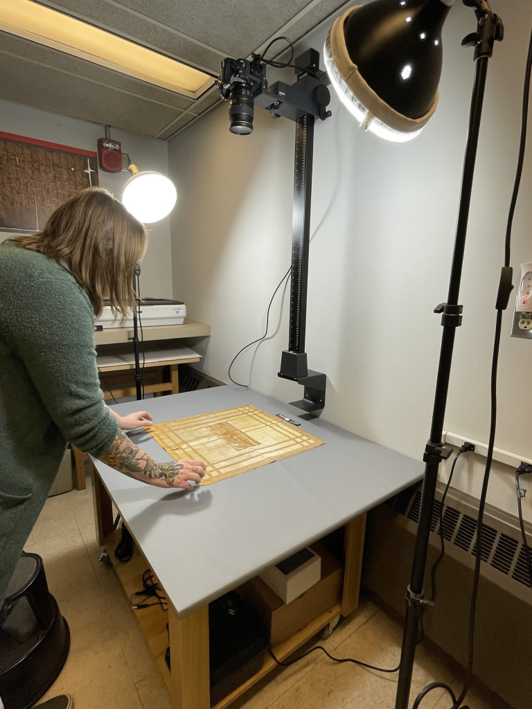 image of Jessica adjusting the silk fabric piece on the copy stand
