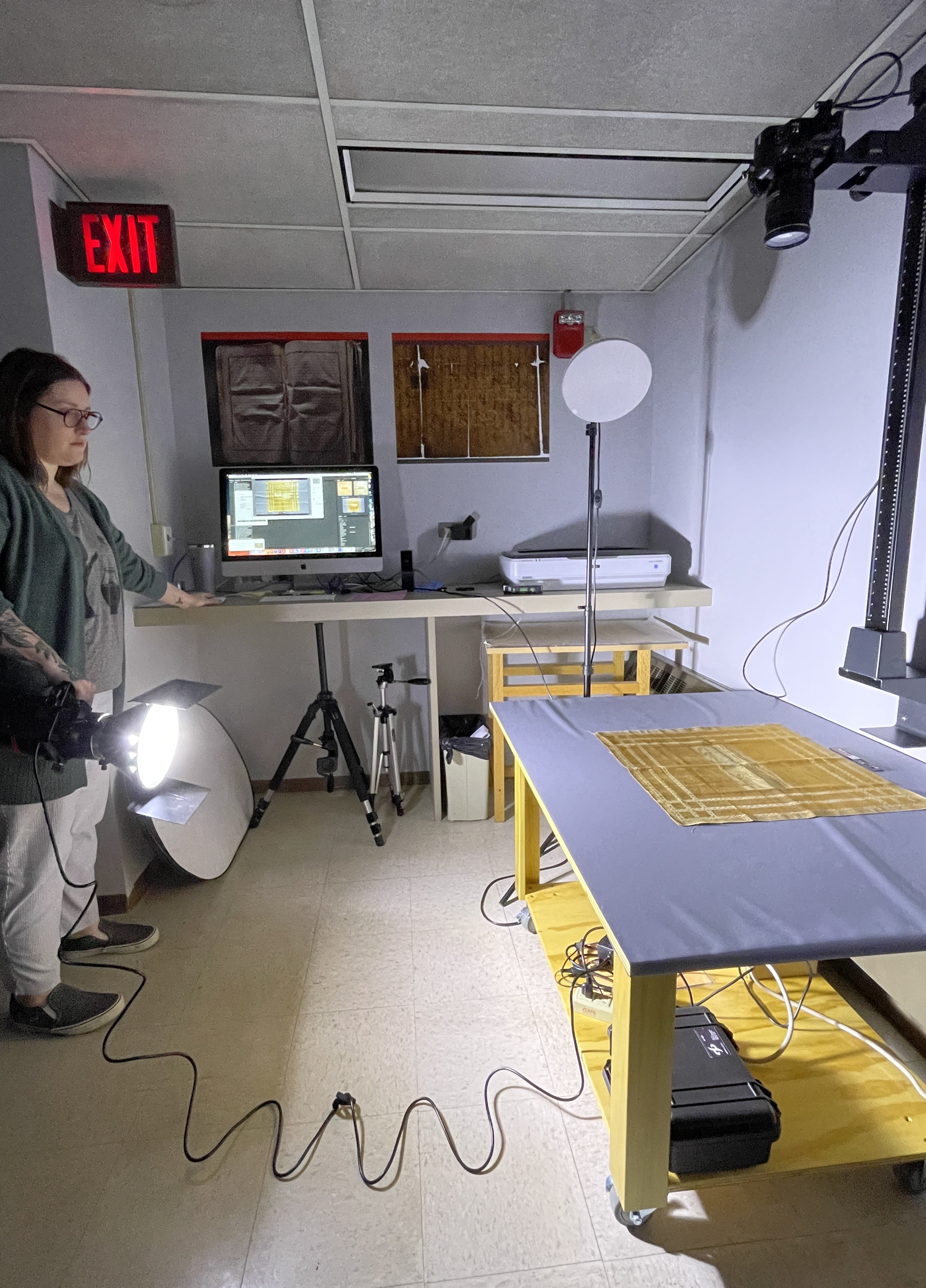 image of Jessica doing raking illumination of the silk fabric piece
