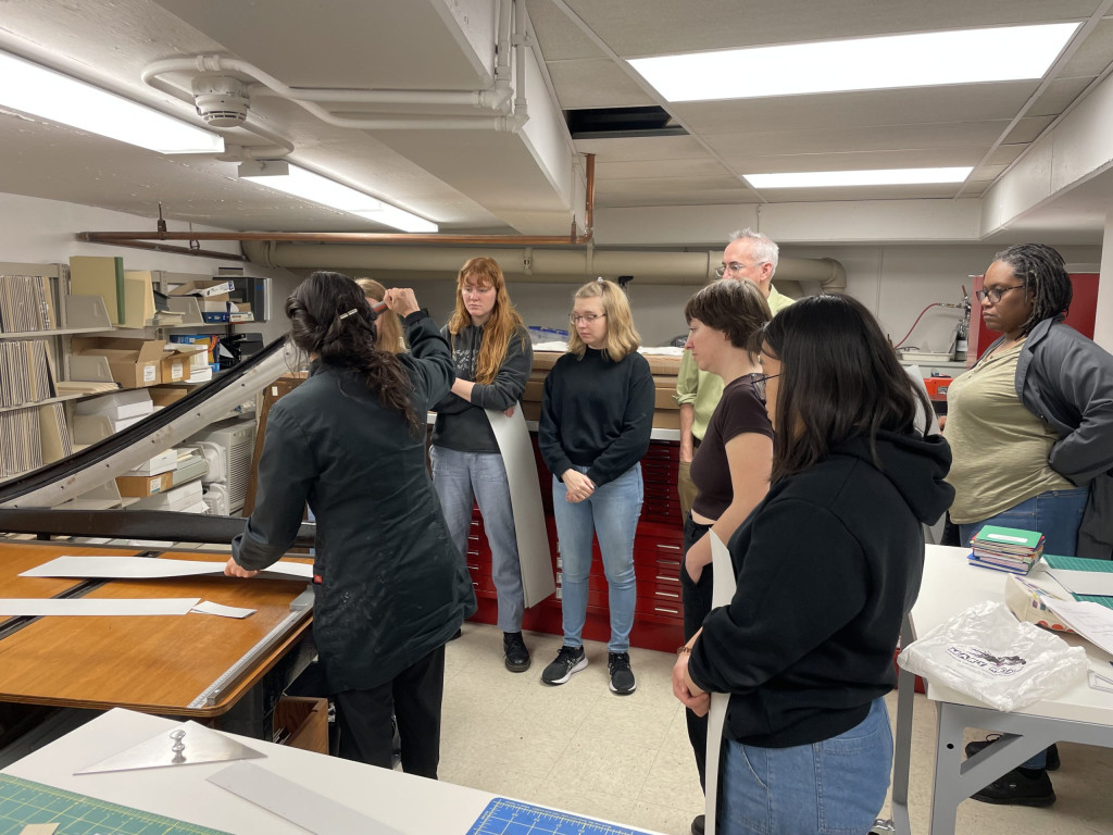 Students learning to use a board shear