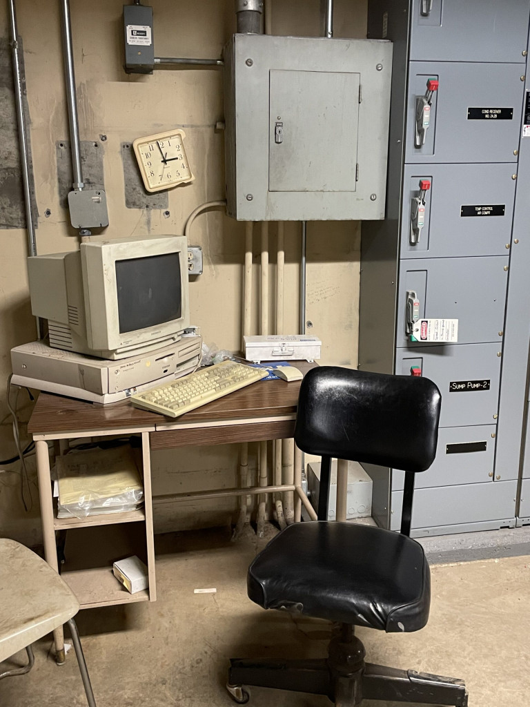 Close up of the work station with a black swivel office chair