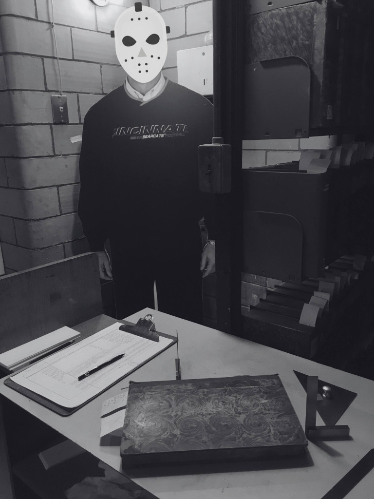 Scary figure wearing a mask in the stacks of the library