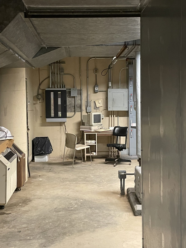 Image of a basement with a small work station to the back