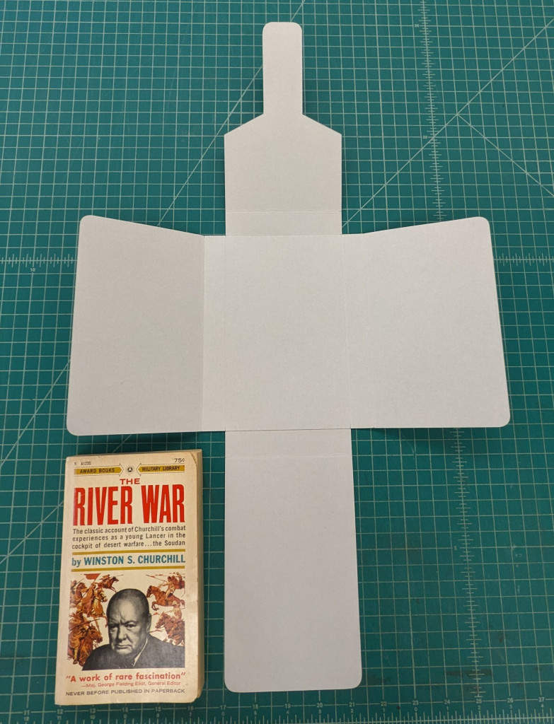 View of a tuxedo box opened next to the book it will house.