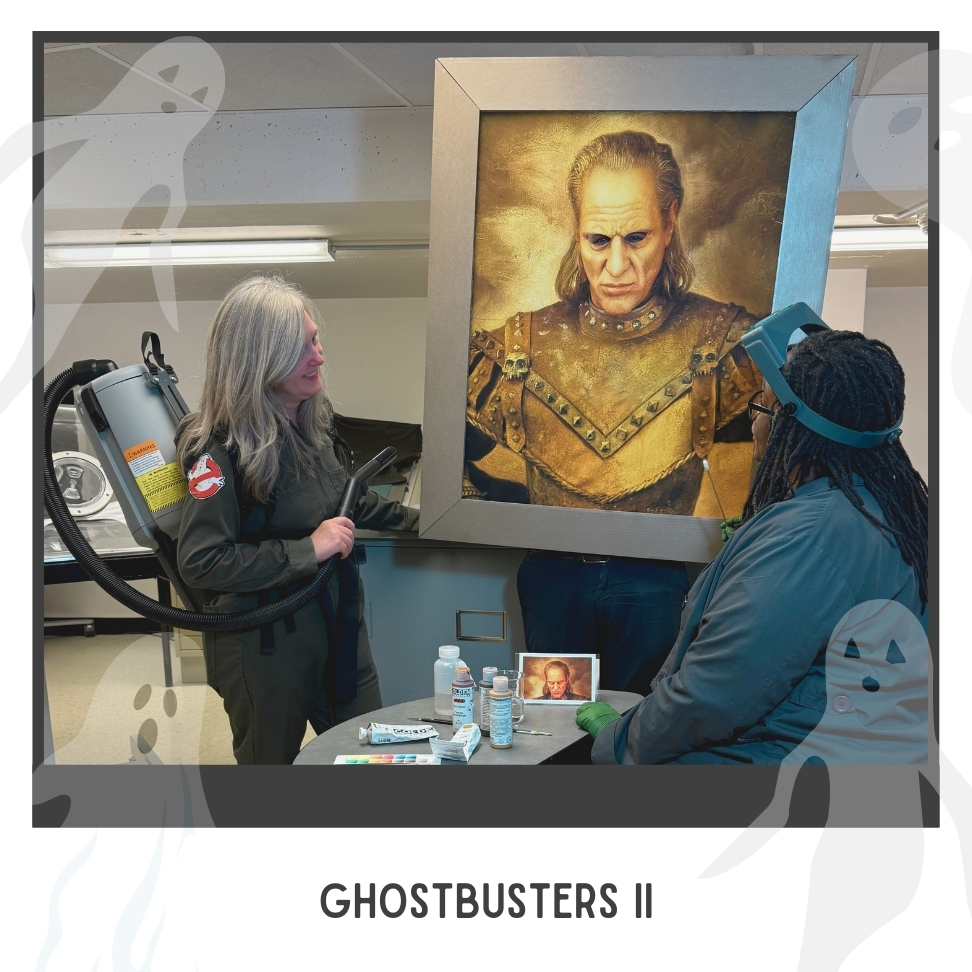 Ghostbuster on the left, painting of old man at the center, conservator seated on the right