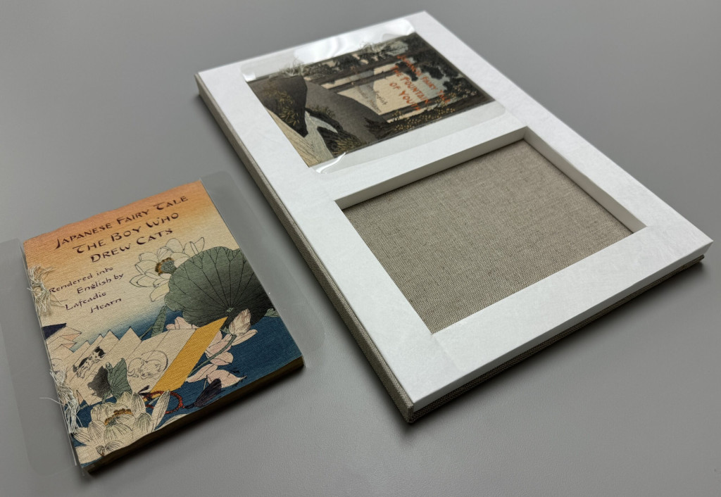 Display tray closed with one set of volumes removed