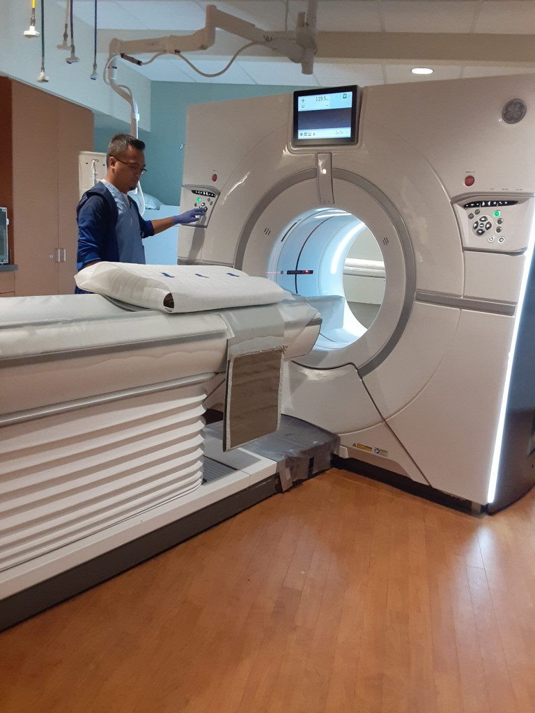 CT imaging tech moving the book into the scanner