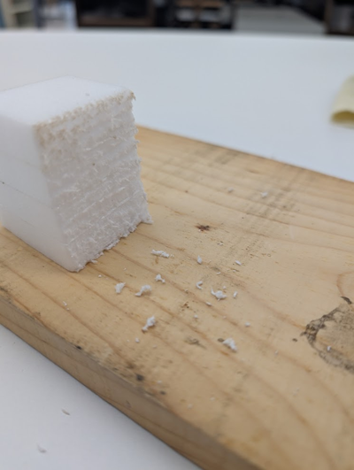 Stack of foam roughly cut with a saw.