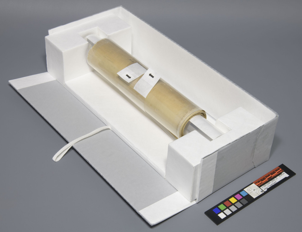 Rolled scroll secured within an enclosure tray