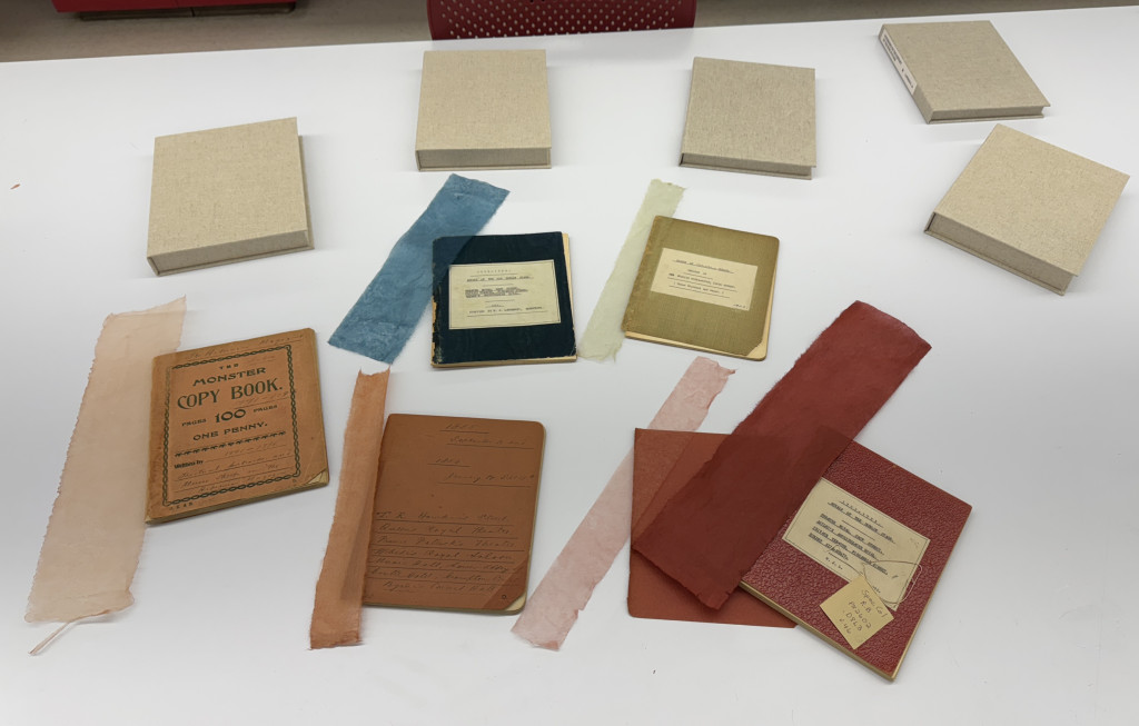 Samples of toned Japanese paper next to the original notebooks to show color matching during treatment.