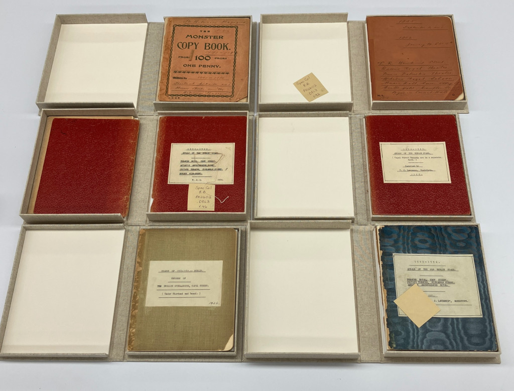 Overhead view of six notebooks with different covers in their enclosures, with the boxes opened.