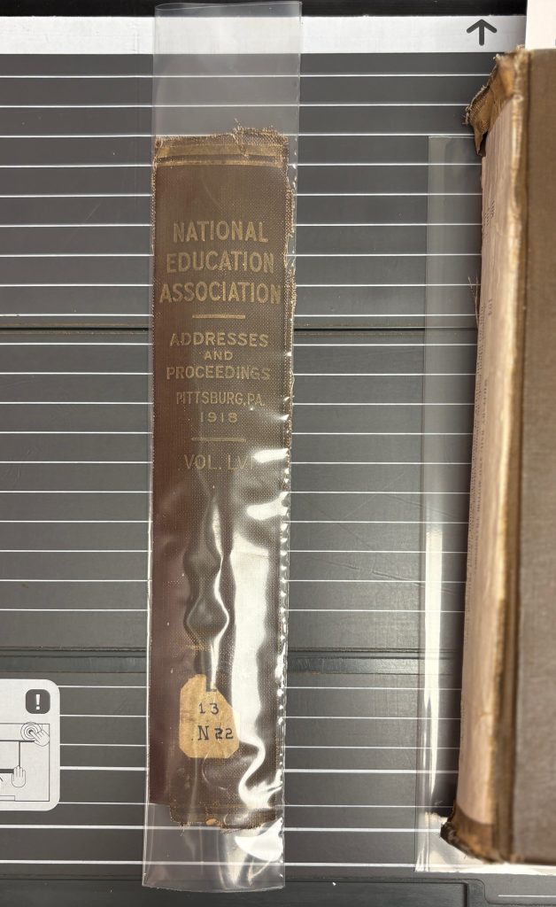 The spine is encapsulated in the polyethylene clear plastic on the long edges.  There is excess plastic material at the top and bottom edge where it is not welded.