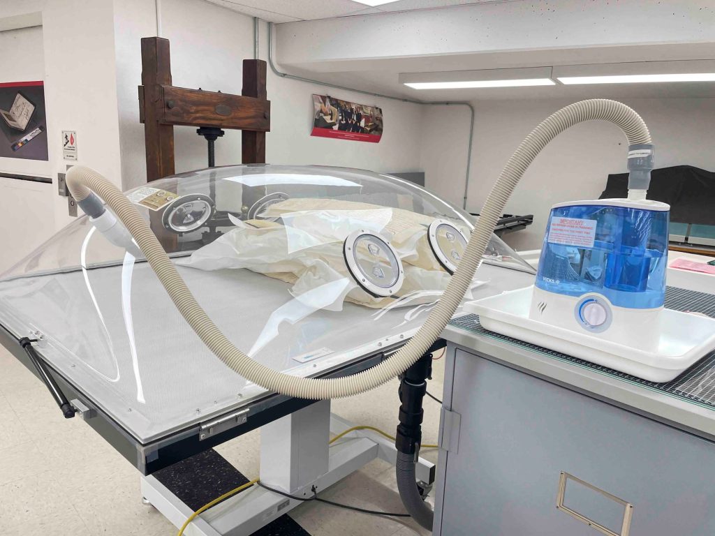 View of the humidification/suction table with parchment documents inside awaiting humidification.