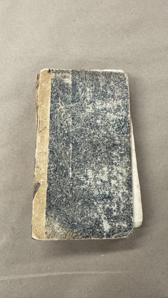 Example of an extra boarded binding with marbled paper covering the boards.