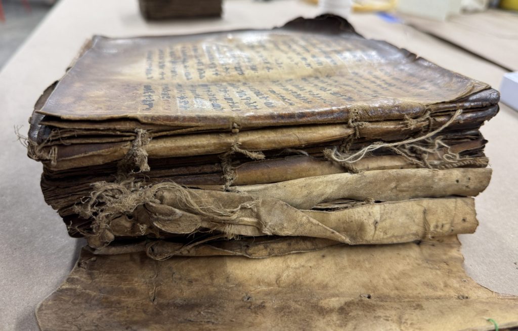 Medium-sized Ethiopian binding with wooden covers and exposed sewing.