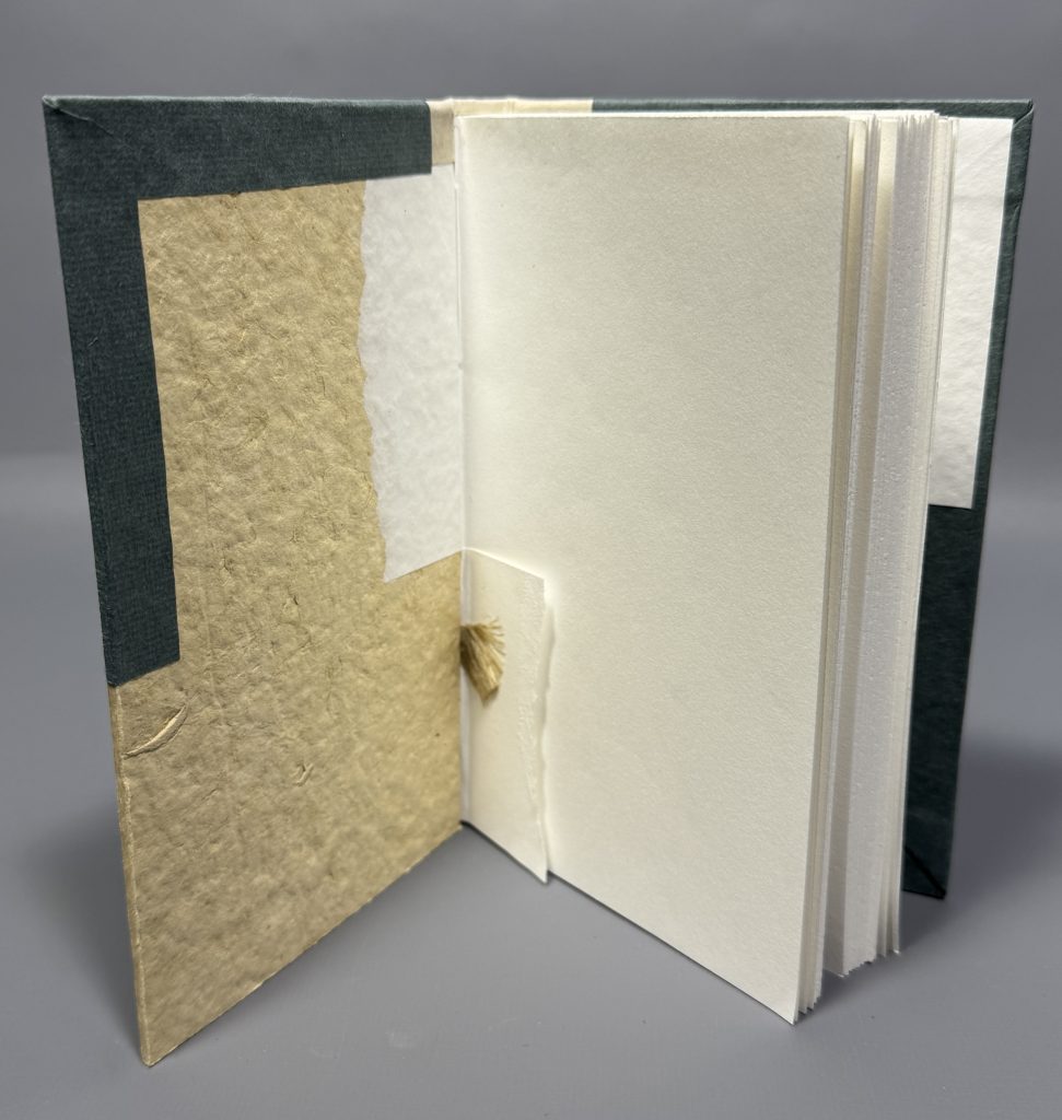 Boarded binding cutaway model showing the inside of the front board, highlighting the pasted on cord attachment.