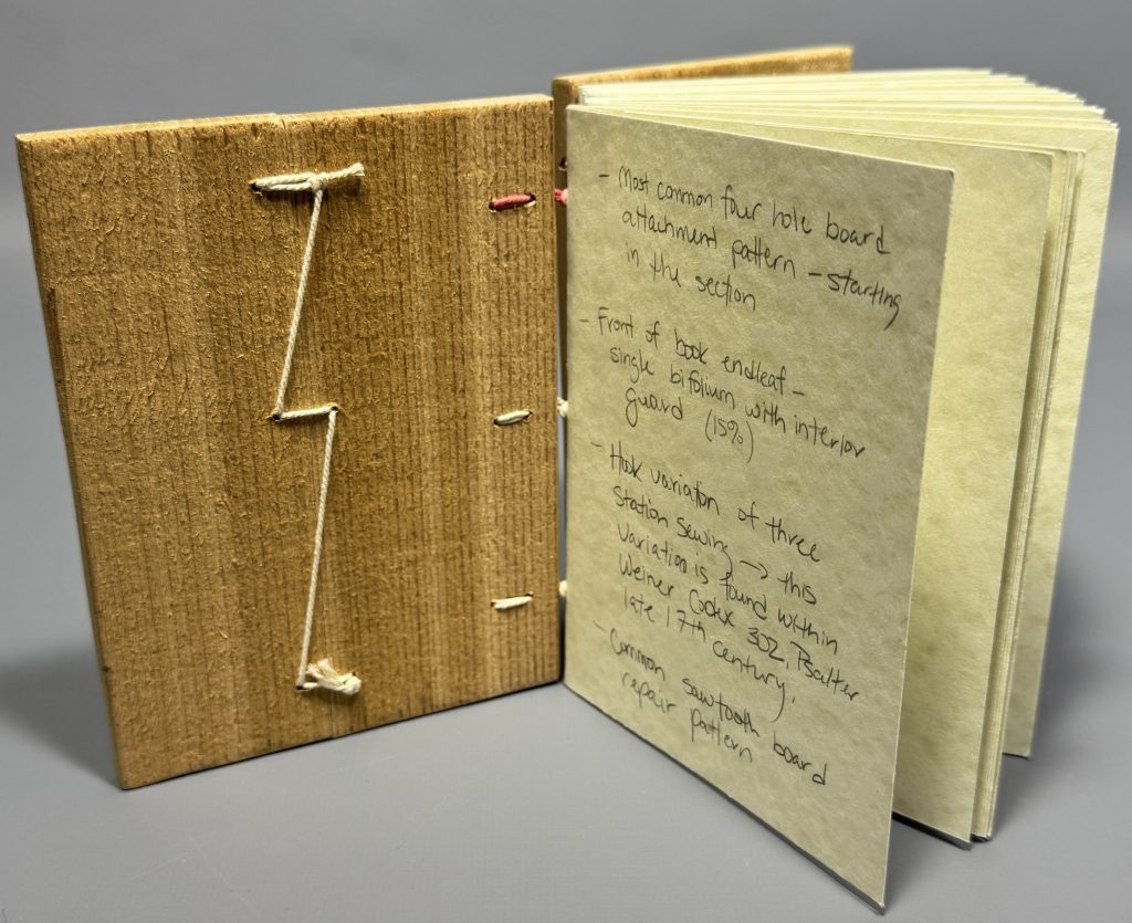 View of the inside of book model to show the thread repair to the broken front board.