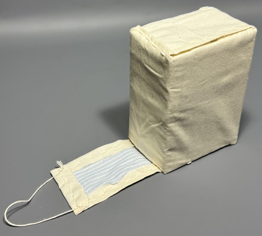 The tab of the textile over-cover wraps around the edges of the text block of the book.